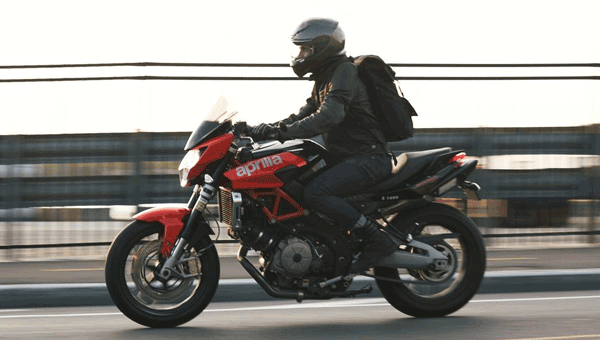 Man Riding Aprilla Motorcycle